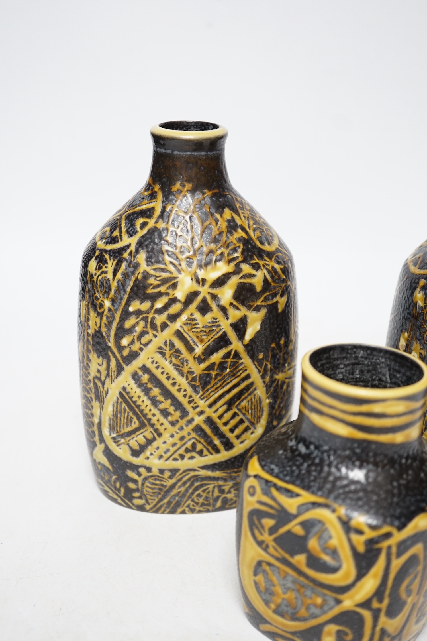 A pair of Royal Copenhagen brown and yellow decorated fajance vases marked 3208 on base and a similar bird decorated squat vase marked 3361 on base, pair of vases 18cm high